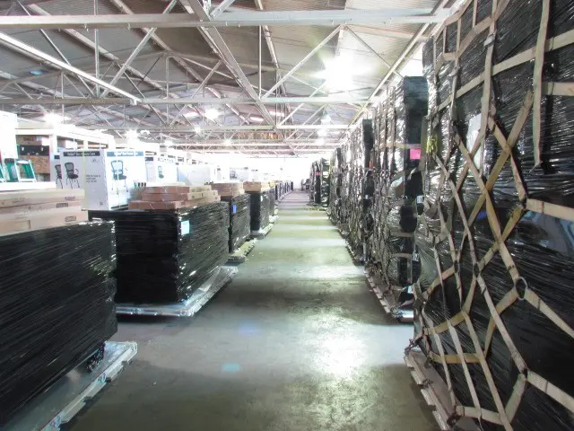 A warehouse filled with lots of boxes and racks.