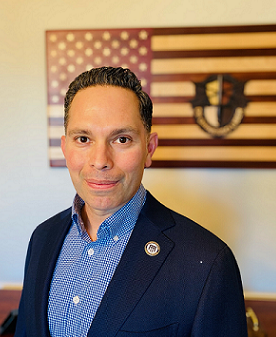 A man in front of an american flag.