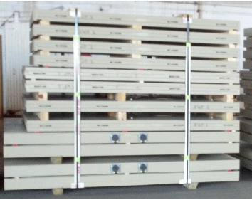 Stacked concrete panels secured with straps.