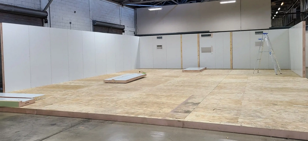 A room with plywood walls and floor.